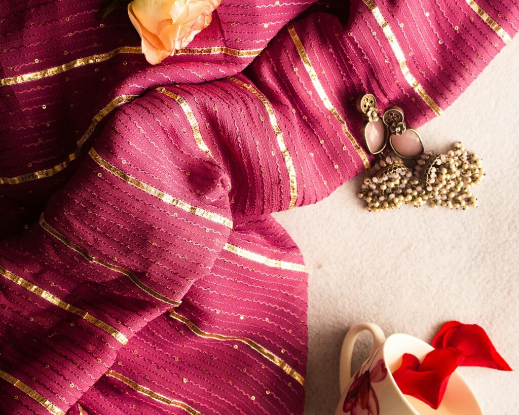 a close up of a scarf with a flower on it