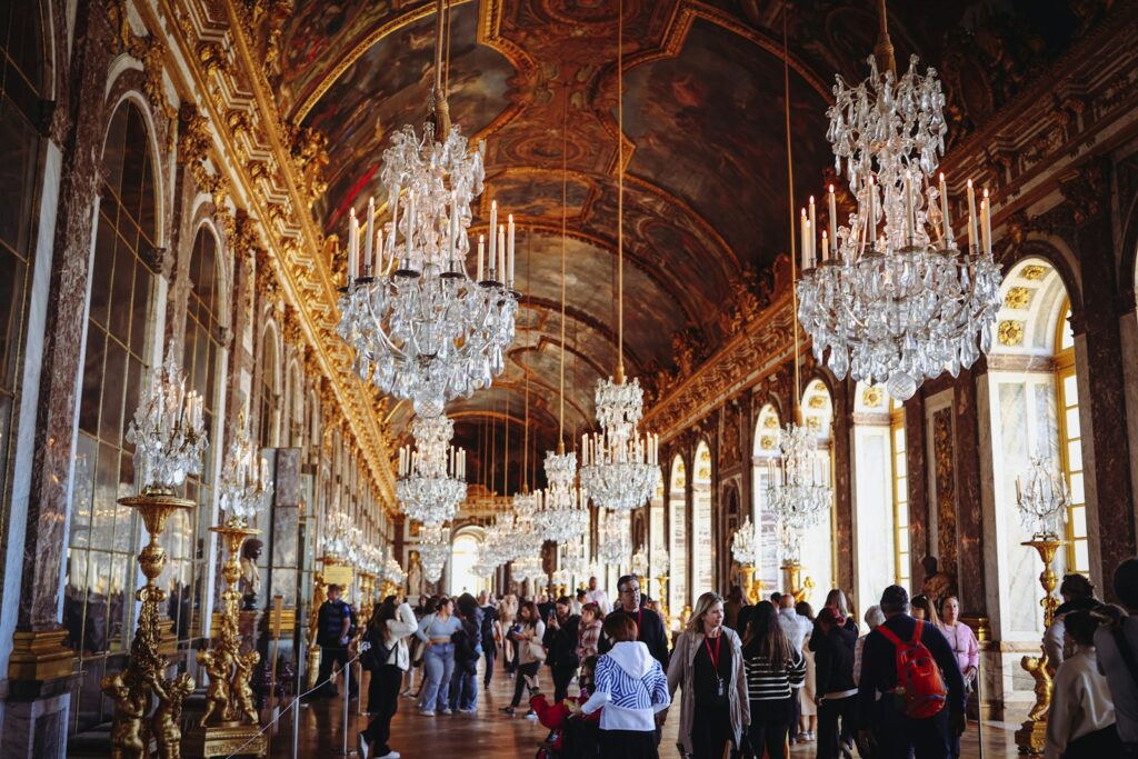 a large room with chandeliers and people walking around
